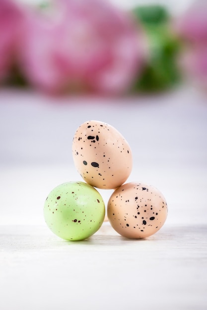 Three pastel Easter eggs on a white background copy space