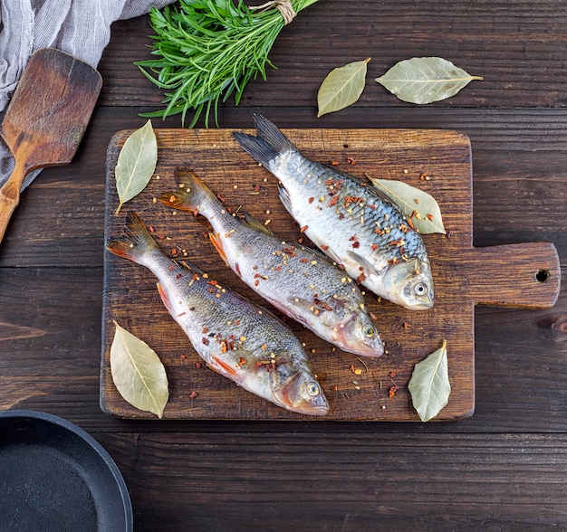 Three peeled river fish with spices 