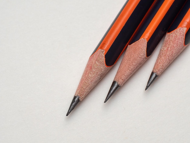 three pencils on a white background