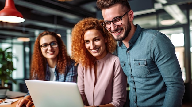 Three people looking at a laptop