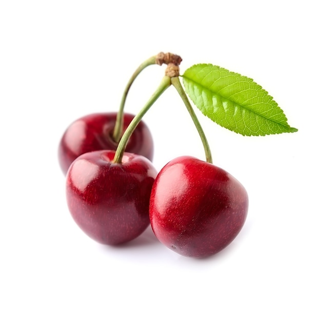 Three ripe cherry with leaves isolated on white