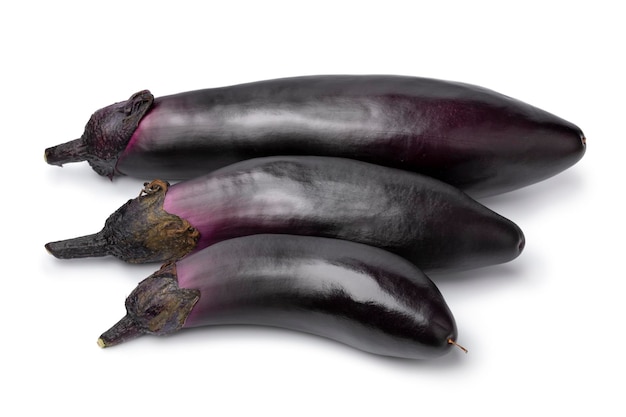 Three ripe purple eggplant close up isolated on white background