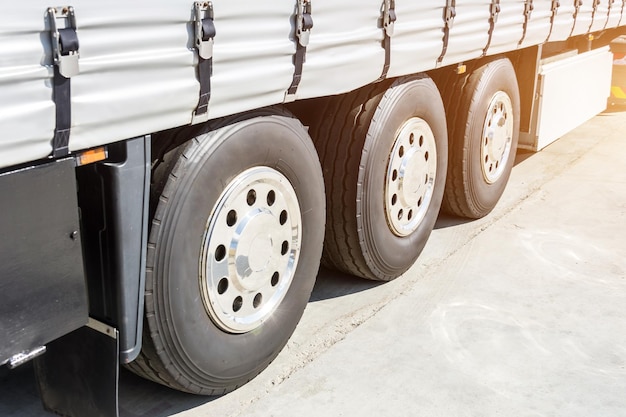 Three shiny chrome wheel of large truck and trailers