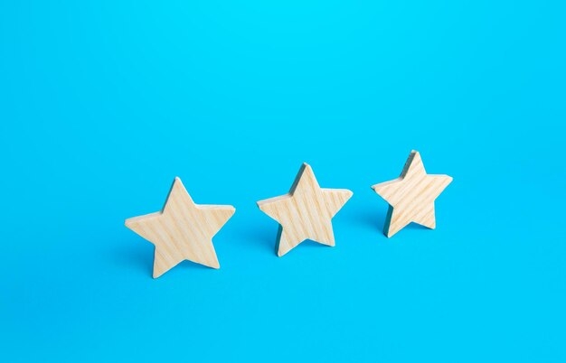 Three stars on a blue background Rating evaluation concept Service quality Buyer feedback High satisfaction Popularity rating of a restaurant hotel or mobile applications Good reputation status