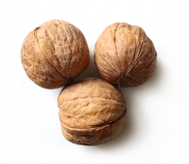 Three walnuts on white background