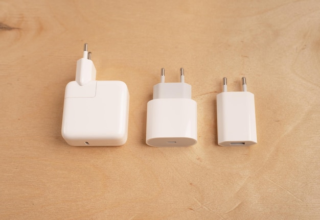 Three white chargers of a different size on a wooden background Space for text