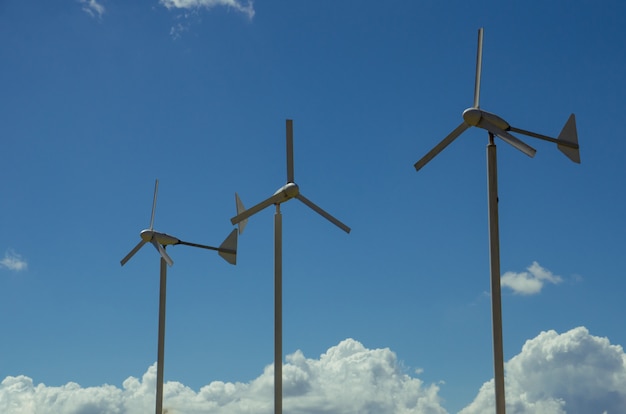 Three wind turbines with blue sky