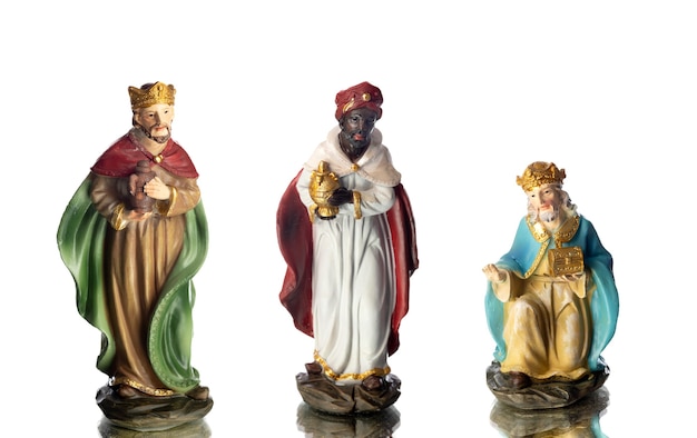 Photo the three wise men. ceramic figures isolated on white background