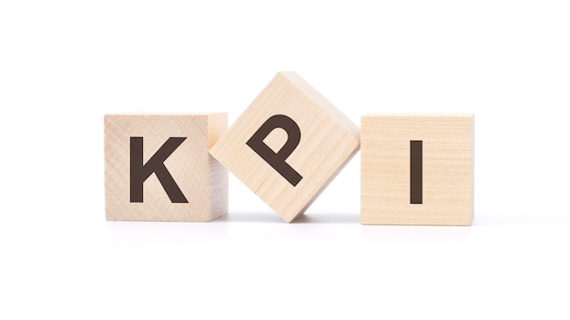 three wooden cubes with the letters kpi on white background Key Performance Indicators concept