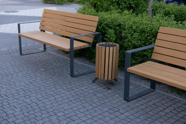 Three wooden litter bins in public area.