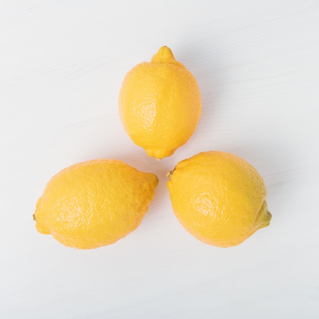 Three yellow lemons isolated on white background.