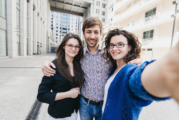 Three young people making selfie