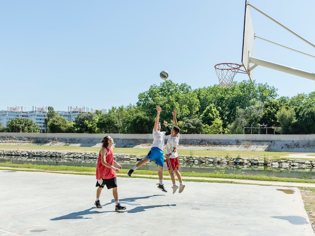 Three young players on the basketball court