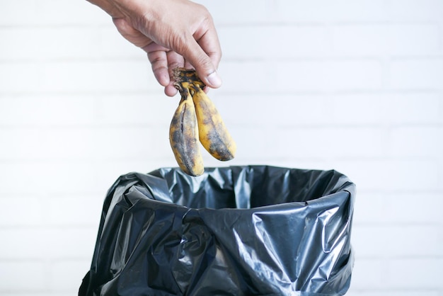 Throwing banana in a garbage bin