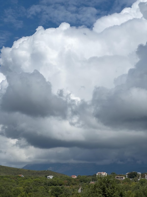 Thunderclouds hang low over the houses in the mountains