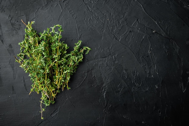 Thyme green fresh bunch, on black table, top view