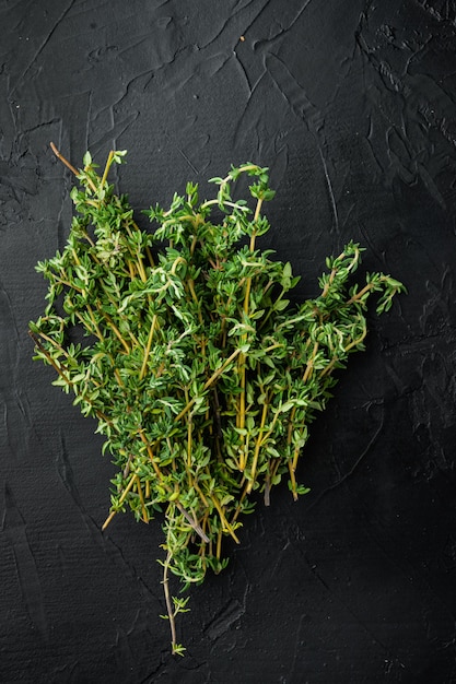 Thyme green fresh bunch, on black table, top view