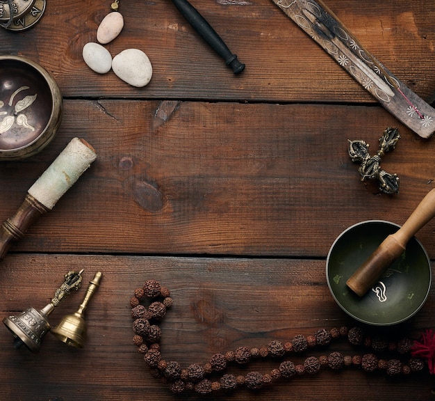 Tibetan singing copper bowl with a wooden clapper objects for meditation and alternative medicine top view Plunging into a trance