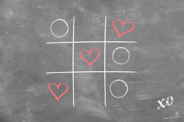 Tic-tac-toe on chalk board won love hearts and valentine's day signed xo