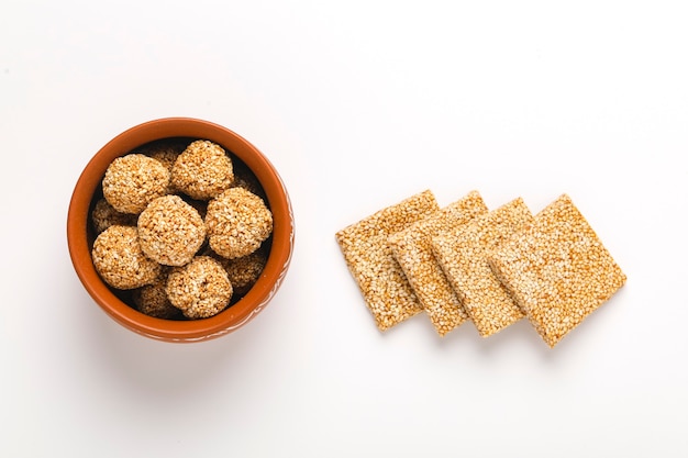 Til chikki and sesame seed ball, Indian sweet dish made with jaggery and sesame seeds.