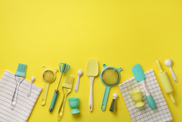 Time to cook. Turquoise cooking utensils on yellow background. Food ingredients