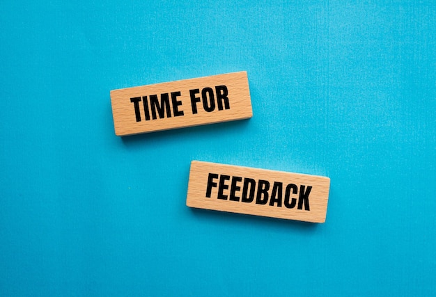 Time for feedback words written on wooden blocks with blue background Conceptual time for feedback symbol Copy space