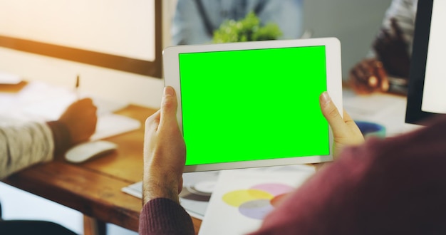 Time to get everyone talking about your business Shot of an unrecognisable businessperson holding a digital tablet with a chroma key screen