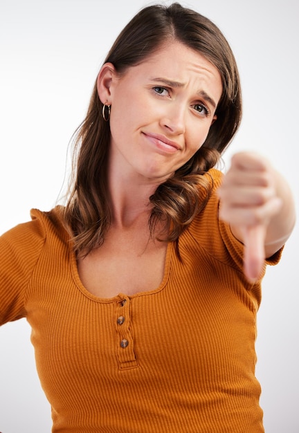 Time to get up for work Studio shot of a young woman showing thumbs down against a white background