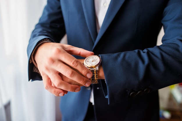 Time is money Businessman pointing on watch Business concept