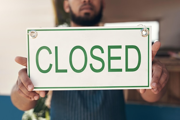 Time to tally up my wins Shot of a businessman holding an open business sign