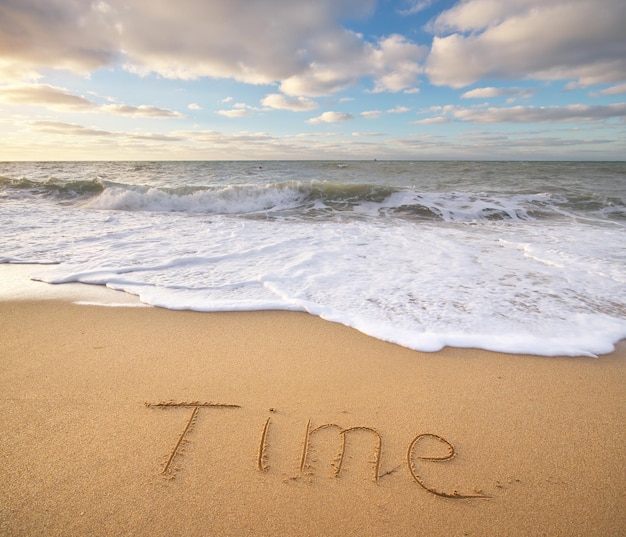 Time word on the sea sand Conceptual nature design