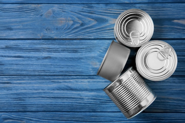 Tin cans on wooden background