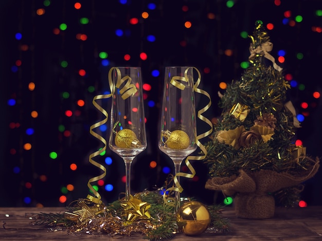 Tinted dark image of Christmas-themed champagne glasses.