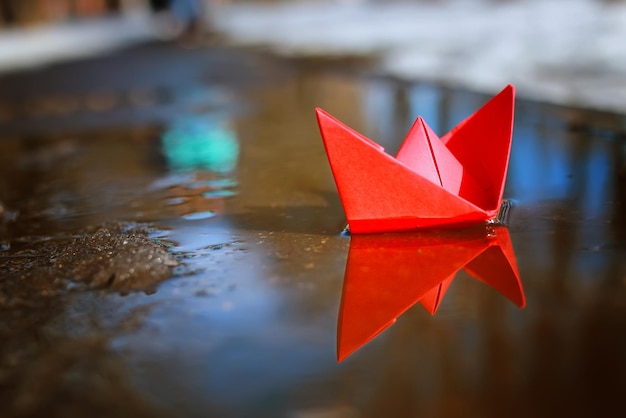 Tinted photo paper boat on spring street