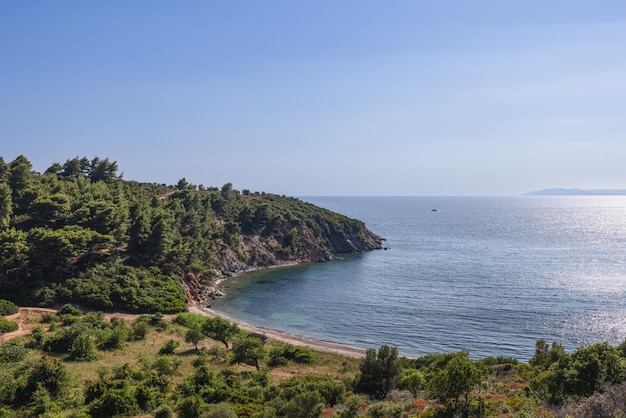 Tiny beach and bay hidden behind steep in Sithonia. Chalkidiki, Greece