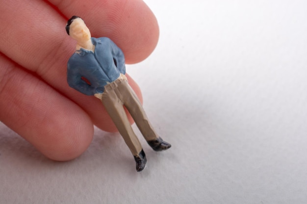 Tiny figurine of man model in hand