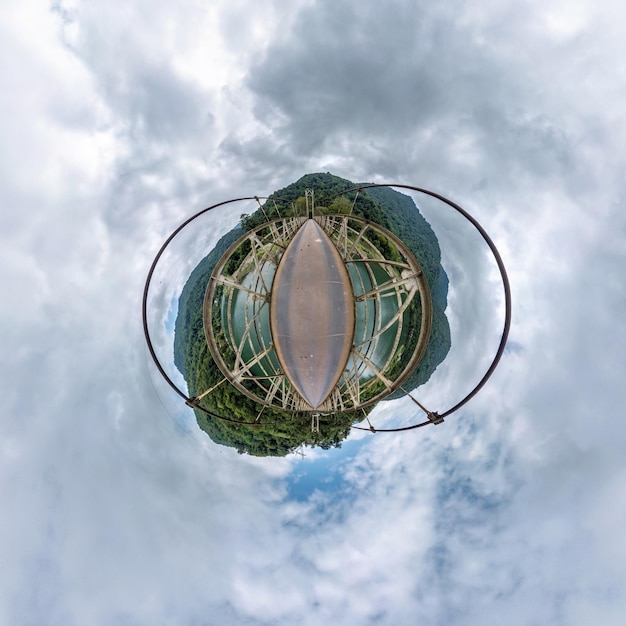 Tiny planet in blue overcast sky with beautiful clouds with transformation of spherical panorama 360 degrees Spherical abstract aerial view Curvature of space