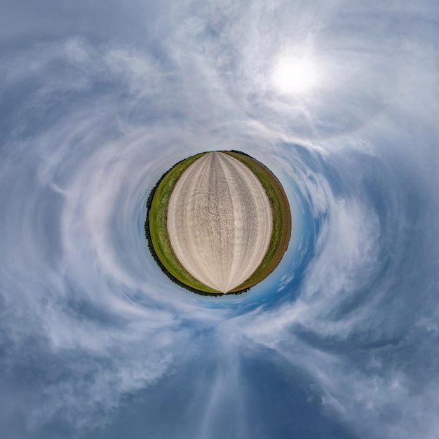 Tiny planet in blue overcast sky with beautiful clouds with transformation of spherical panorama 360 degrees Spherical abstract aerial view Curvature of space