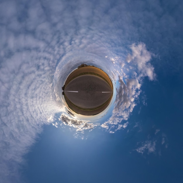 Tiny planet in blue sky with beautiful clouds Transformation of spherical panorama 360 degrees Spherical abstract aerial view Curvature of space