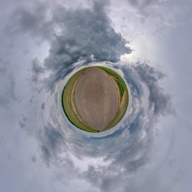 Tiny planet in blue sky with beautiful clouds Transformation of spherical panorama 360 degrees Spherical abstract aerial view Curvature of space