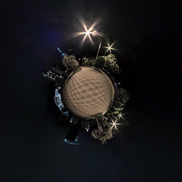 Tiny planet in night sky with clouds in modern multistorey multiapartment residential complex of urban development Transformation of spherical 360 panorama in abstract aerial view