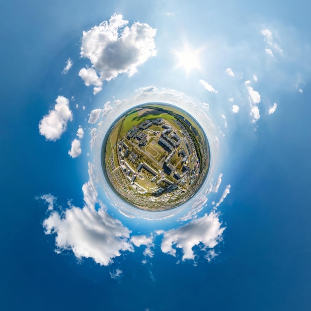 Tiny planet in sky with clouds overlooking old town urban development historic buildings and crossroads Transformation of spherical 360 panorama in abstract aerial view