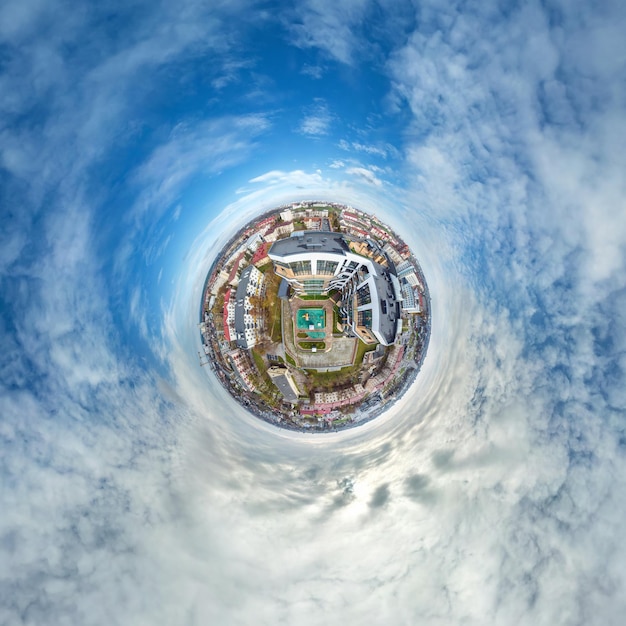 Photo tiny planet in sky with clouds overlooking old town urban development historic buildings and crossroads transformation of spherical 360 panorama in abstract aerial view