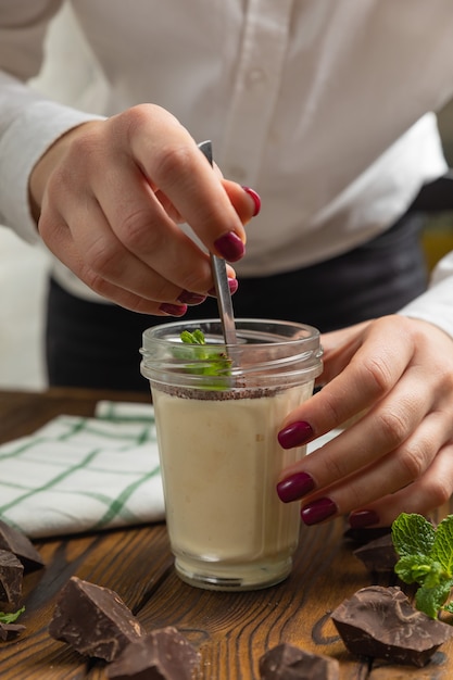 Tiramisu in a glass on a brown wooden table