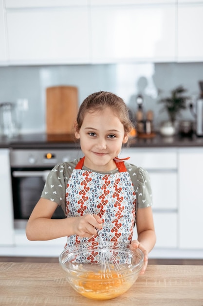 Tiramisu making process in the kitchen little girl making Italian desert with cocoa and espressodipped ladyfingers with mascarpone cream step by step 5