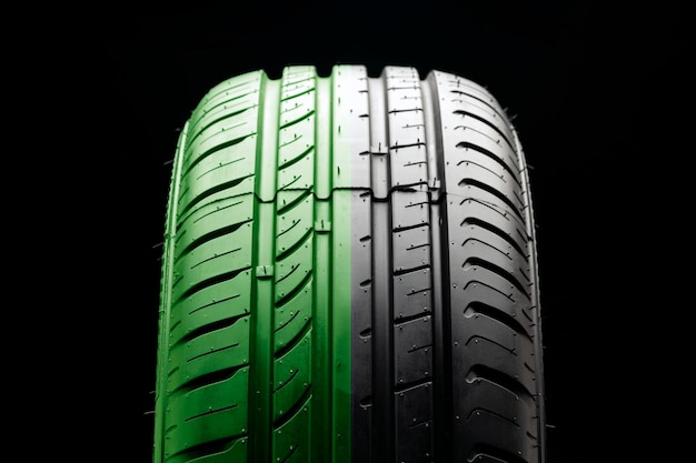 Tire tread closeup half green the concept of an ecofriendly economical tire fuel economy and safety