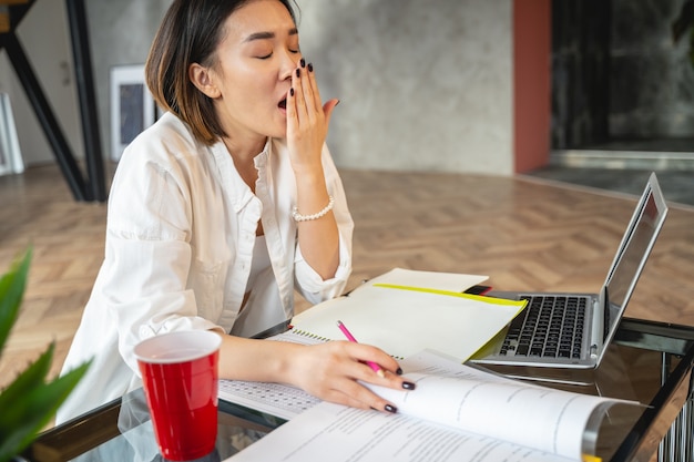 Tired business lady making project at her workplace in office