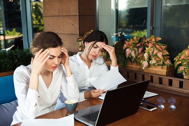 Tired business women having headache at office. Hard work