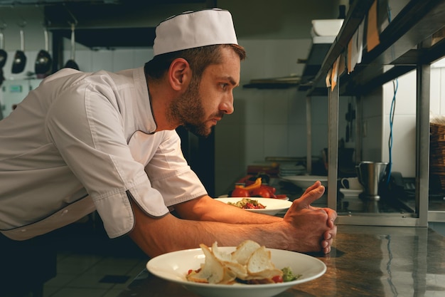 Tired chef on kitchen restaurant waiting for a new order