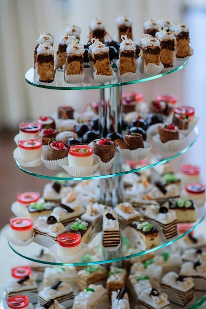 Tired glass dishes with cold jelly cakes and bakery